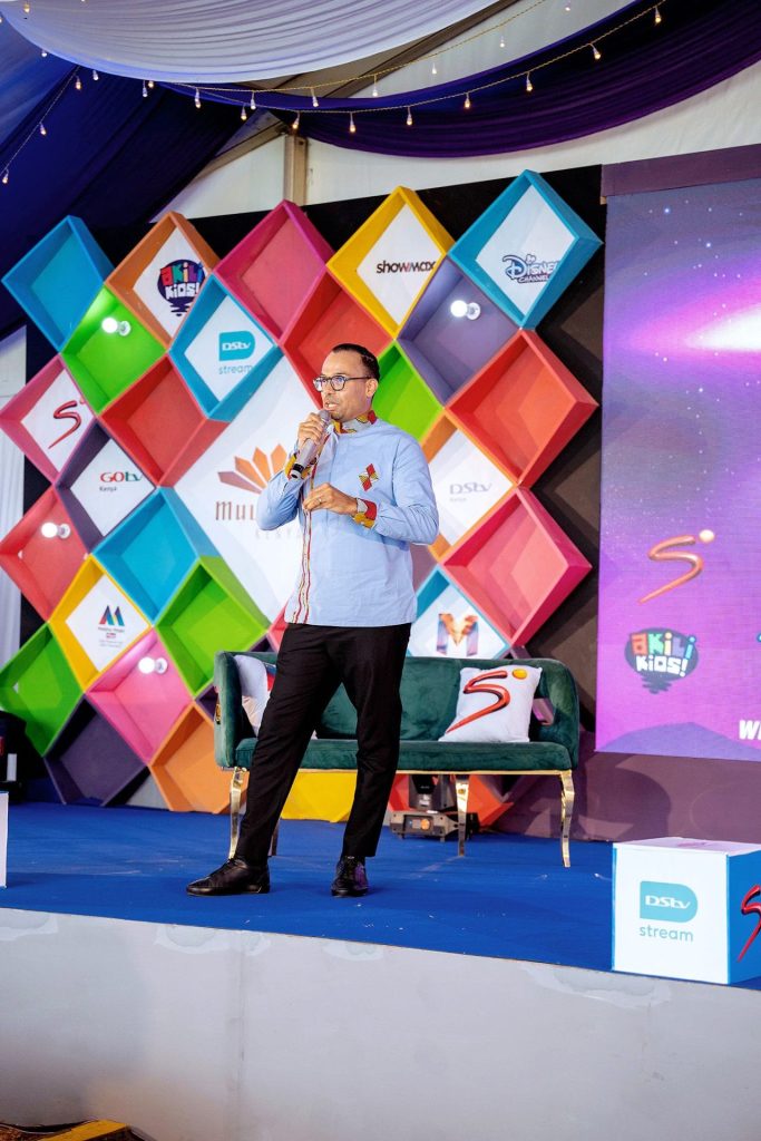 A man on a stage holding a microphone at the Multichoice content showcase